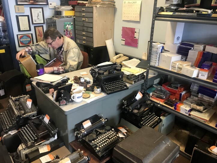 Tom Furrier inspects a typewriter case at Cambridge Typewriter Company.