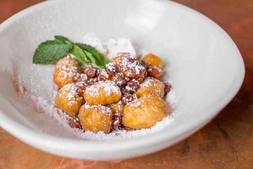 Maple-glazed zeppolis with bacon, powdered sugar and mint.