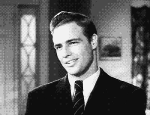 A man smiles and rolls his eyes