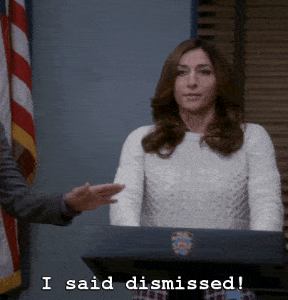A woman standing at a podium says "I said dismissed!"