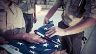 Boy Scouts fold an American flag during a ceremony at their camp in Colorado.