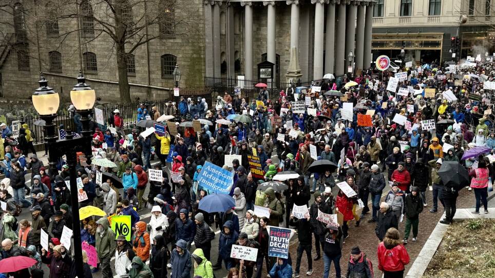 View of Tremont Street in Boston as a large crowd marches from Boston Common to Boston City Hall.