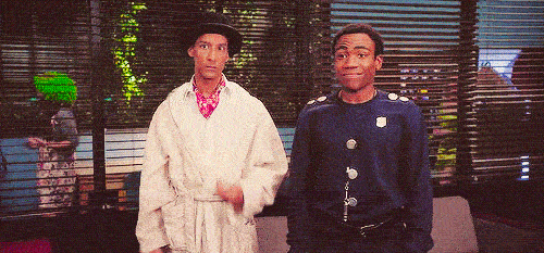 Two men do a very groovy high five.