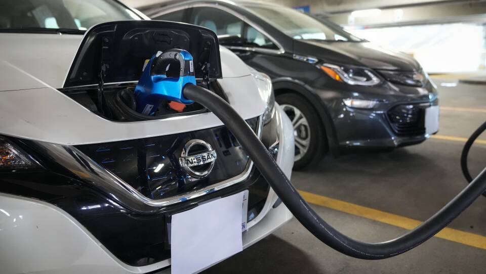 Electric vehicles are displayed at a news conference with White House Climate Adviser Gina McCarthy and Secretary of Transportation Pete Buttigieg in Washington, D.C., on April 22, 2021. The Biden administration's climate and health care bill passed by Congress last week revamps a tax credit for buyers of electric cars.