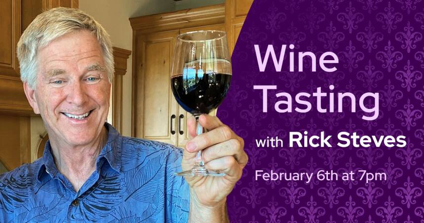 Rick Steves holding up a glass of red wine and smiling at the camera