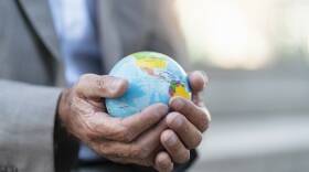 Close-up of hands of businessman holding globe