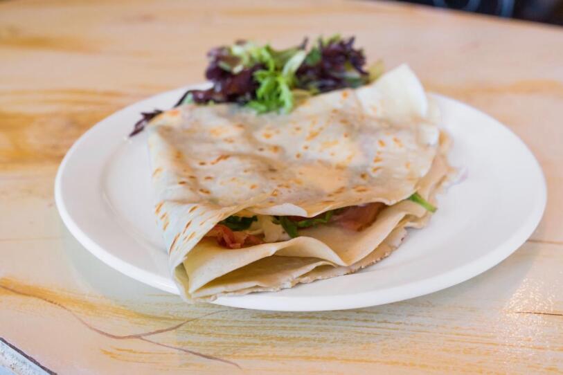 The “Affectation”, a savory crepe with bacon, goat cheese, arugula, and fig reduction.