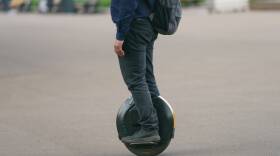 Young man driving Electric unicycle on the Moscow city street