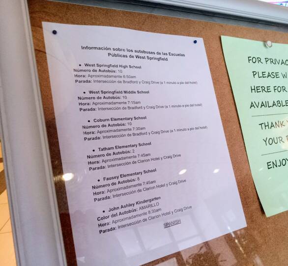 A school bus schedule is posted in the lobby of a hotel in West Springfield, Massachusetts. The hotel is one of many being used by the state as an emergency shelter to house thousands of families, many who have recently come into the U.S.