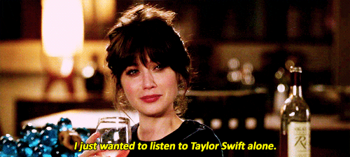A crying woman brandishes a wine glass and says "I just wanted to listen to Taylor Swift alone."