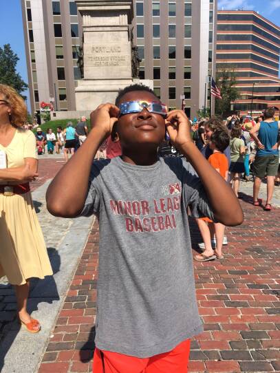  Sammy Anderson views the solar eclipse through special glasses in Maine in 2017.