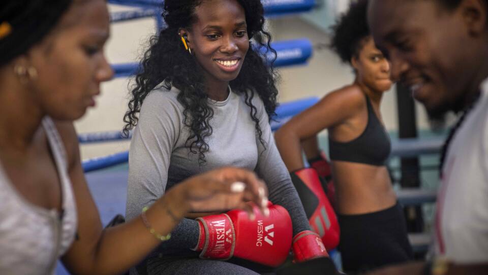 Boxer Legnis Cala, center, talks with fellow female boxers during a training session in Havana, Cuba, Monday, Dec. 5, 2022. Cuban officials announced on Monday that women boxers would be able to compete for the first time ever.