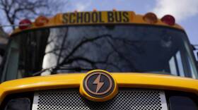 A lightning bolt icon marks the front hood of a school bus.