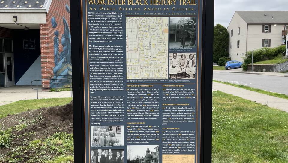 A sign with photos and writing.