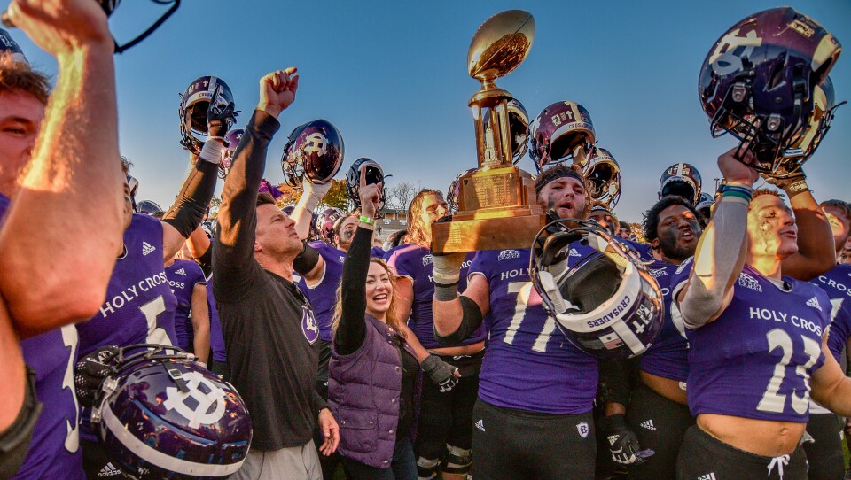 A packed high school football stadium filled with fans supporting their teams in the year the blog focuses on