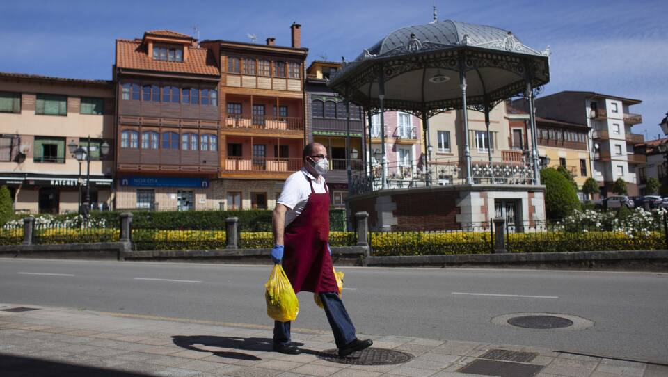 The new EU economic forecast reflects a total drop of 9 percentage points since last fall's forecast, as businesses have been shut down or forced to operate at severely limited capacity. Here, a man delivers a butcher shop order in Norena, Spain, on Wednesday.