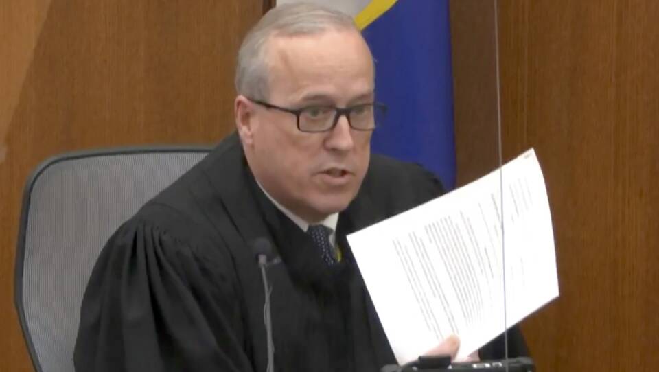 In an image taken from video on Monday, Hennepin County Judge Peter Cahill reads instructions to the jury before closing arguments in the trial of former Minneapolis police officer Derek Chauvin.