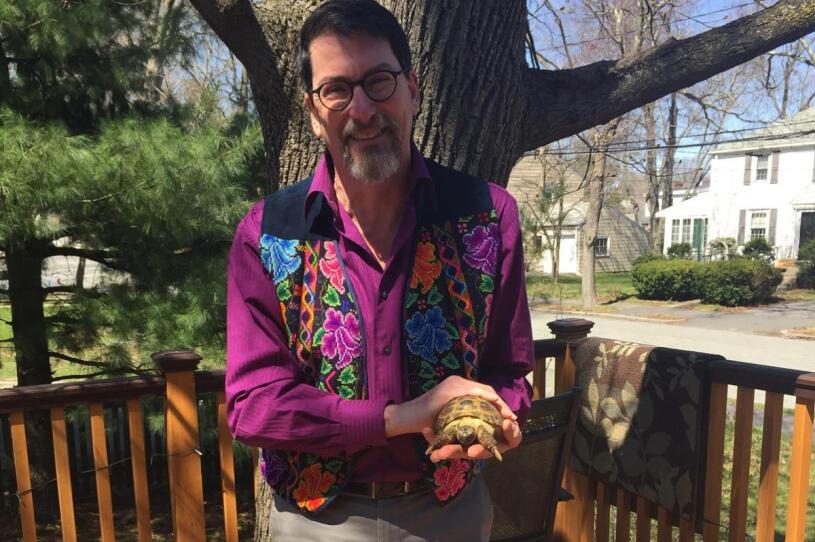 Tea sommelier Hillel Bromberg with his pet tortoise, Maya, at home in West Newton.