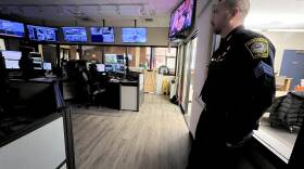 Barnstable Police Sgt. Corey Frederickson stands in the dispatch center at police headquarters.