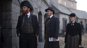 Tim Chipping as Detective Phelps, Felix Scott as Nash and Kate Phillips as Eliza Scarlet. Eliza and Nash look frustrated, while Phelps is pleased.