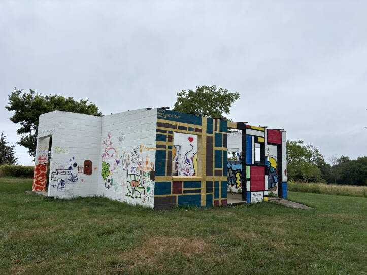 A concrete building covered in graffiti