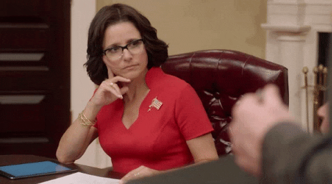A woman raises her eyebrows, unimpressed.