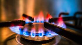 Blue and orange flames on gas hob