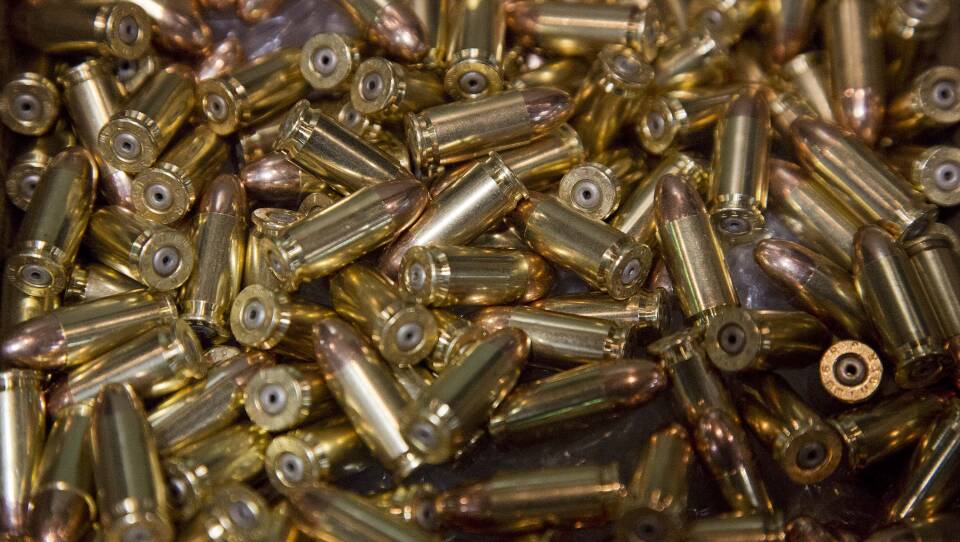 A large pile of shiny copper and brass bullets.
