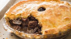 Pie stuffed with chunks of steak and mushrooms with brown gravy