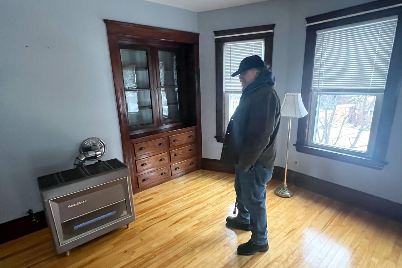 A man stands in his apartment