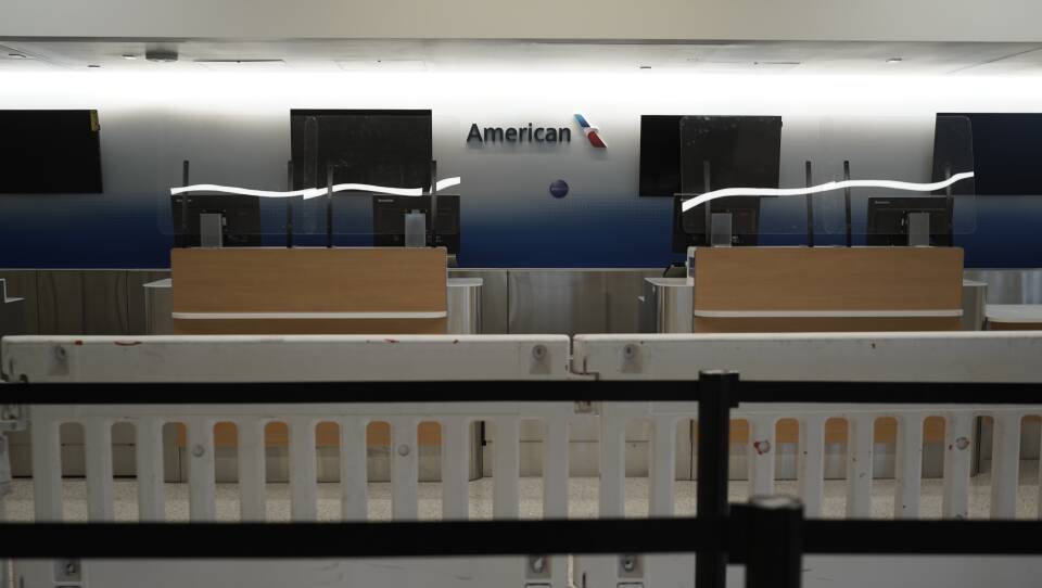 American Airlines check-in counters sit closed last month behind plastic barriers at Los Angeles International Airport.