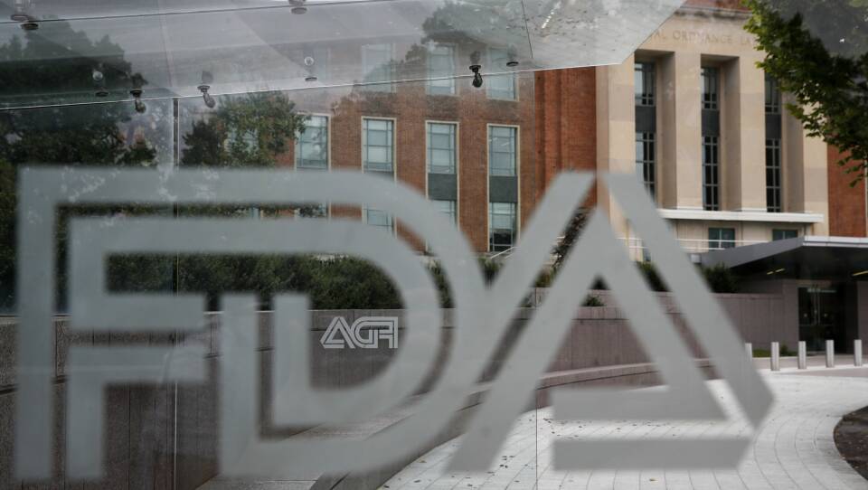 In this Aug. 2, 2018, file photo, the U.S. Food and Drug Administration (FDA) building is visible behind FDA logos at a bus stop on the agency's campus in Silver Spring, Md.