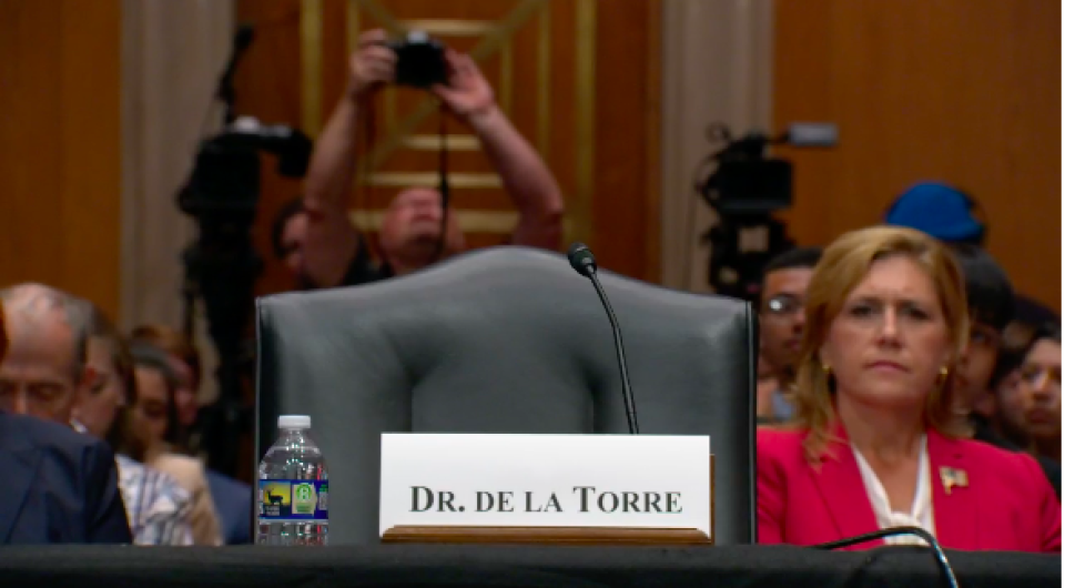 An empty chair in a Senate hearing roomm.