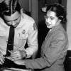 A police officer fingerprints Rosa Parks.