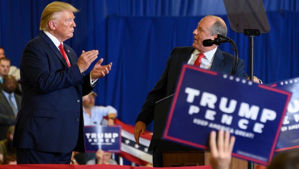 President Trump on stage with Republican congressional candidate Dan Bishop, right, during a campaign rally in Fayetteville, N.C., Monday.