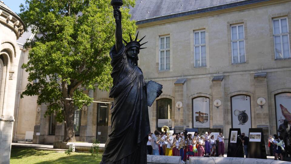 A mini replica of the French-designed Statue of Liberty will reach the U.S. on July 1. Here, the statue awaits its move in Paris on Monday.