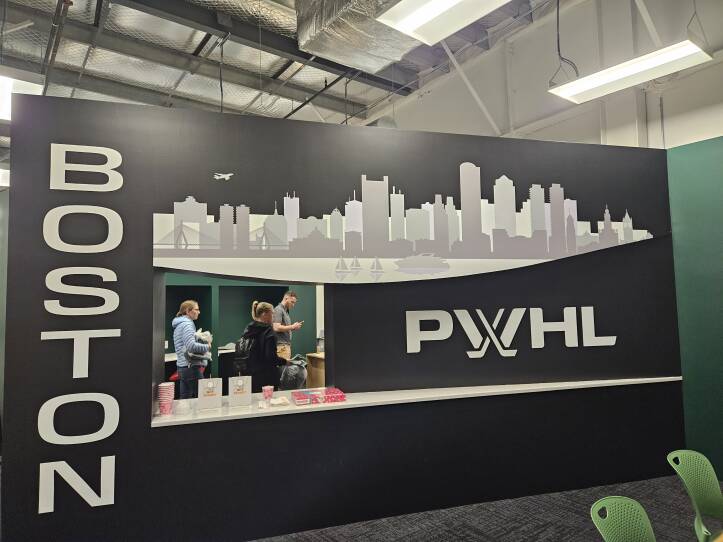 A black wall with a city skyline and the word Boston in bold letters on it.