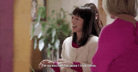 A woman smiles and says "I'm so excited because I love mess."