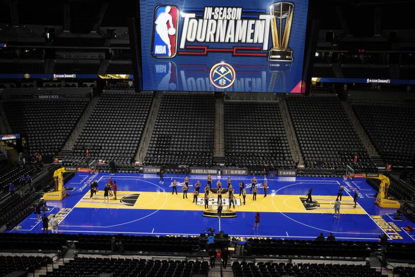 A zoomed-out view of a basketball court, with blue and yellow floors.