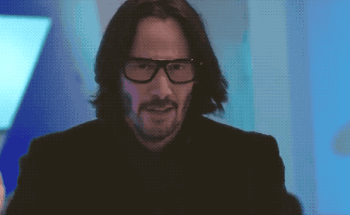 Keanu Reeves smiles and shrugs