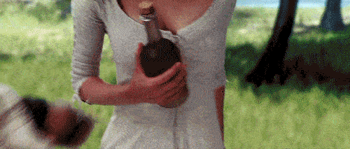 A woman stuck on a deserted island contemplates a bottle of rum