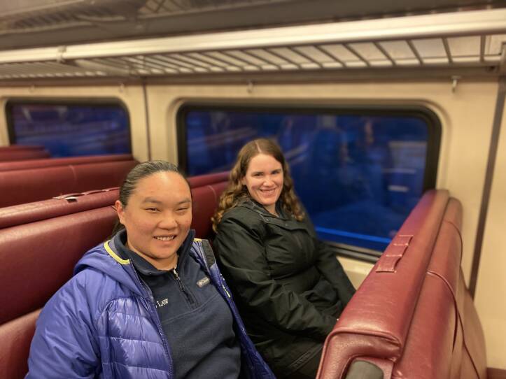Two women sit on a train