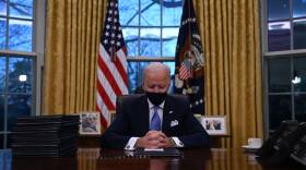 President Biden sits in the Oval Office at the White House after being sworn in as the 46th president of the United States on Wednesday.
