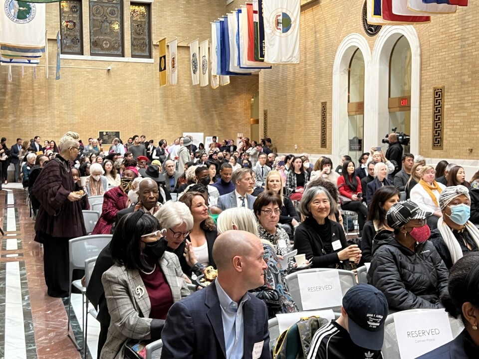 People sit in rows in a room at the State House