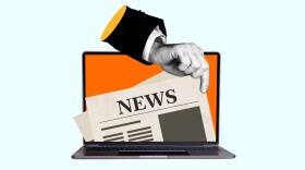 An illustration shows a hand reaching into a laptop with news on it.