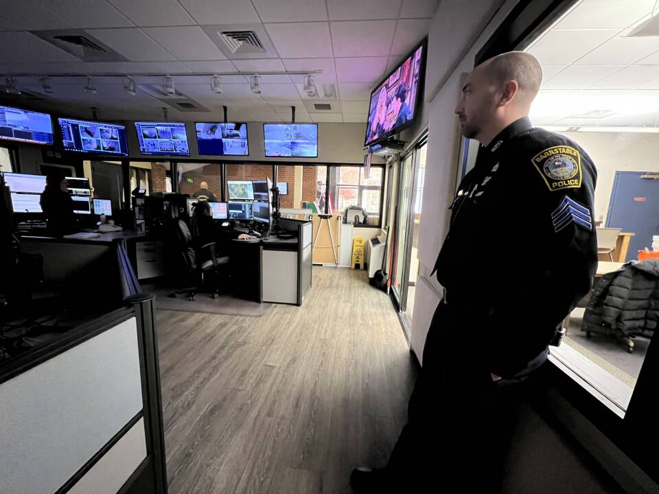 Barnstable Police Sgt. Corey Frederickson stands in the dispatch center at police headquarters.