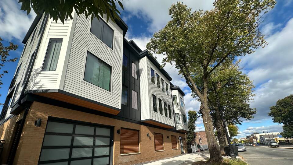 A three-story building in East Boston that's several units wide.