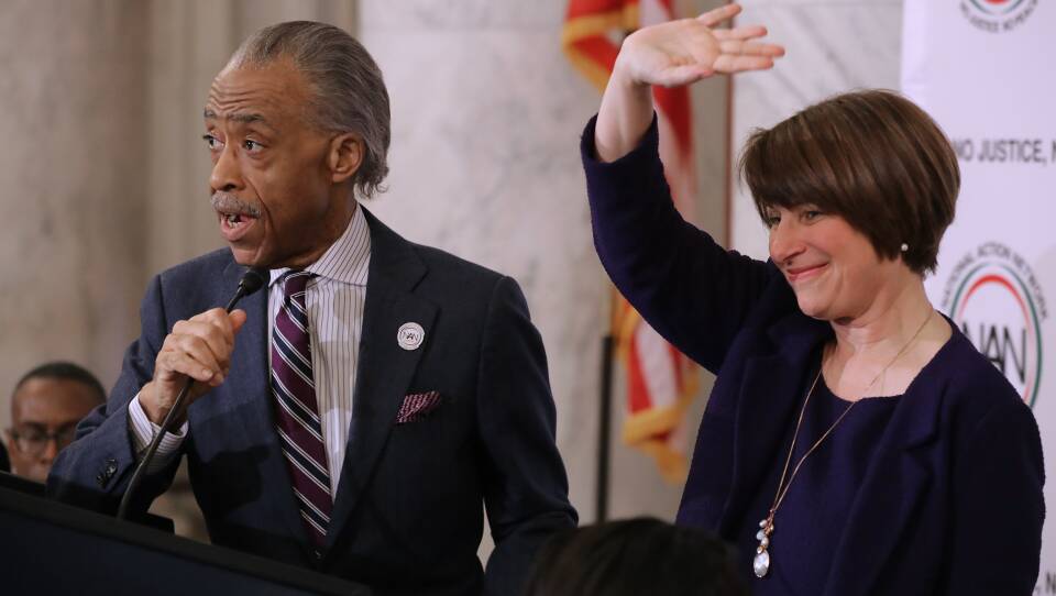 The Rev. Al Sharpton and Sen. Amy Klobuchar, D-Minn. at a November 2018 meeting of Sharpton's National Action Network on Capitol Hill. Klobuchar and other Democrats weighing a presidential bid have been courting the black community more intensively than past election cycles.