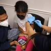 A child receives the Pfizer BioNTech vaccine at the Fairfax County Government Center in Annandale, Va., last November. Vaccines will soon be available for children as young as 6 months old.