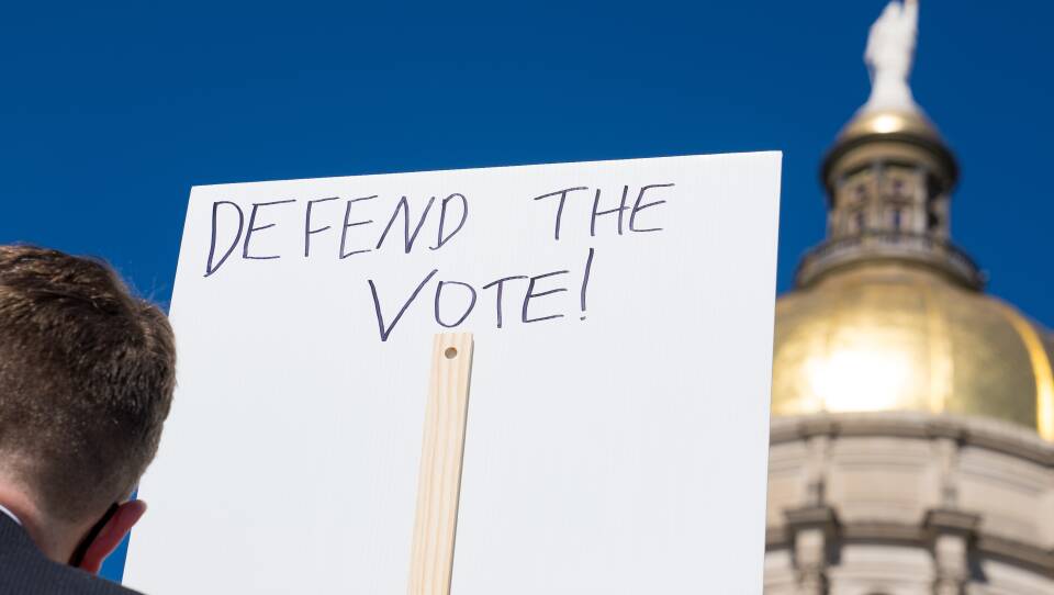 Demonstrators protest House Bill 531 last month in Atlanta. The sweeping voter legislation signed into law has drawn vocal criticism from voting-rights activists and businesses, who say it limits access to the polls and disproportionately harms voters of color.